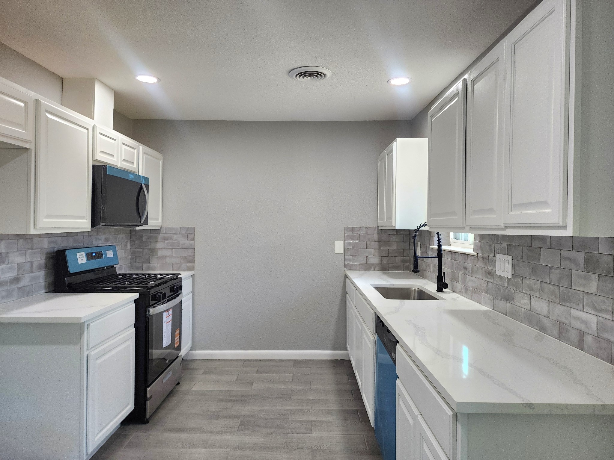5914 Newquay Street Houston, TX 77085 - Photo 1 of 43 a kitchen with stainless steel appliances granite countertop a sink stove and microwave
