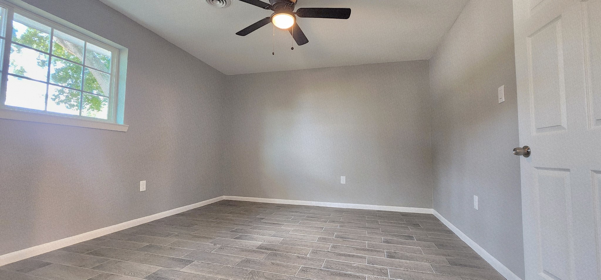 5914 Newquay Street Houston, TX 77085 - Photo 13 of 43 wooden floor in an empty room with a window