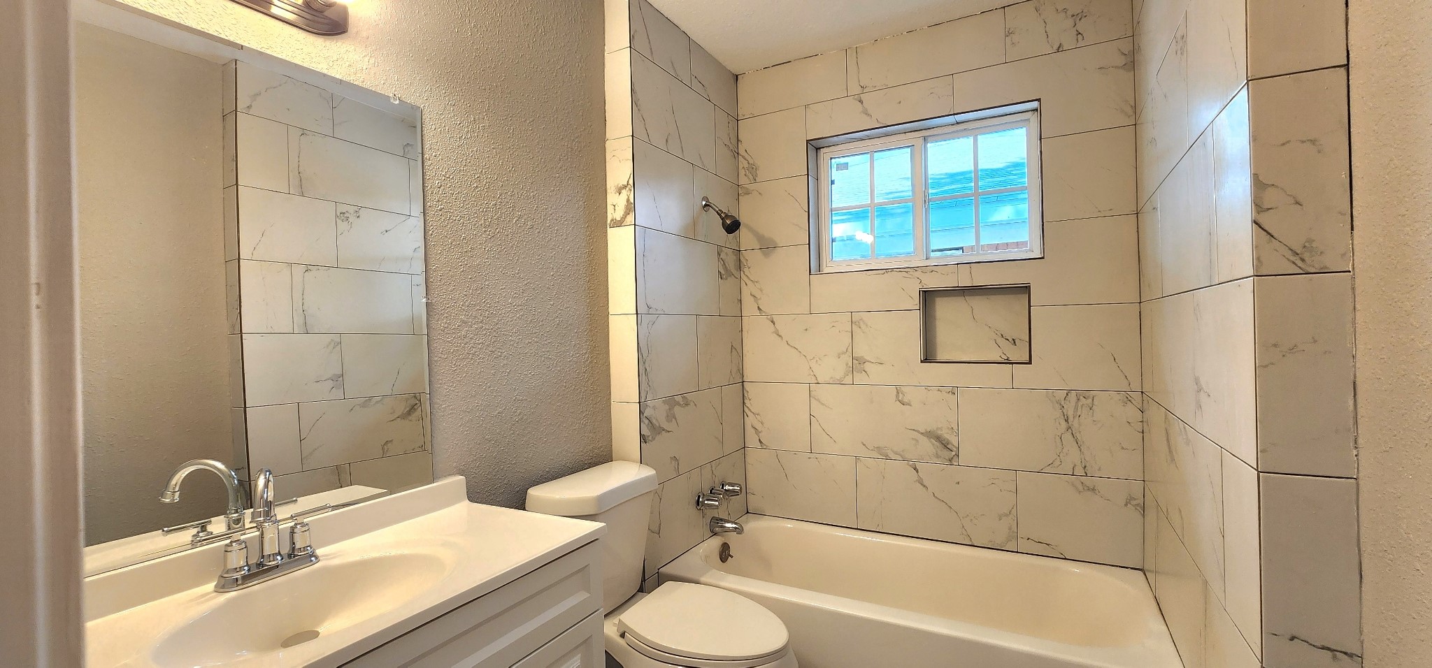5914 Newquay Street Houston, TX 77085 - Photo 19 of 43 a bathroom with a granite countertop sink toilet and shower