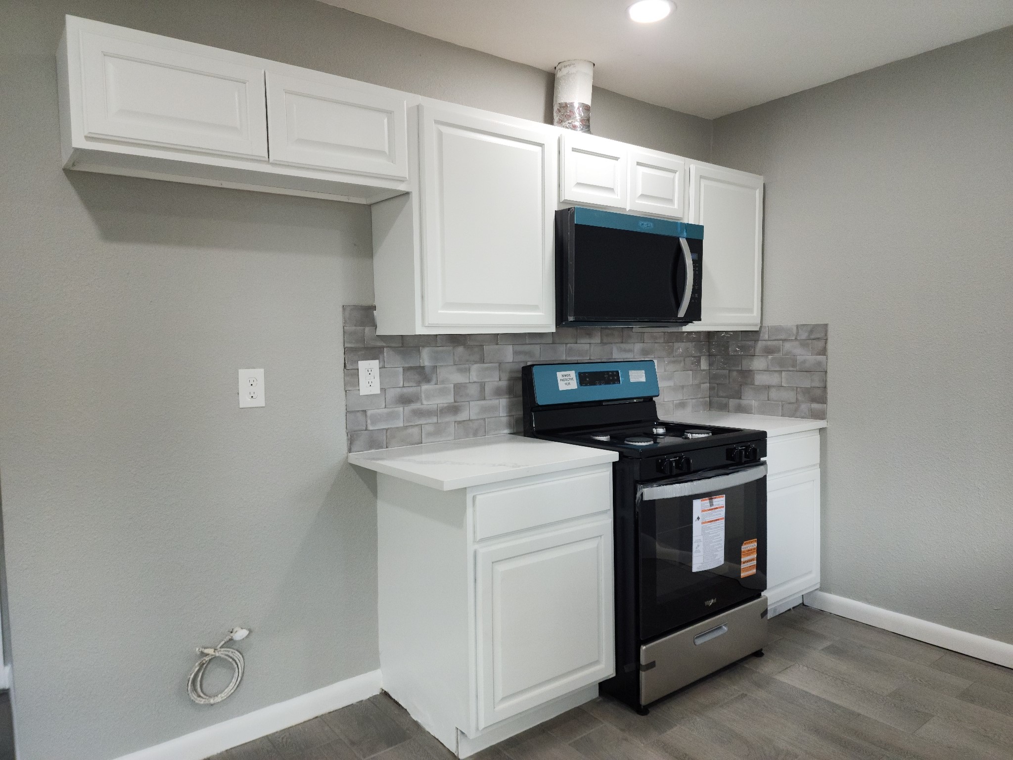 5914 Newquay Street Houston, TX 77085 - Photo 24 of 43 a kitchen with stainless steel appliances granite countertop a stove a microwave and a sink