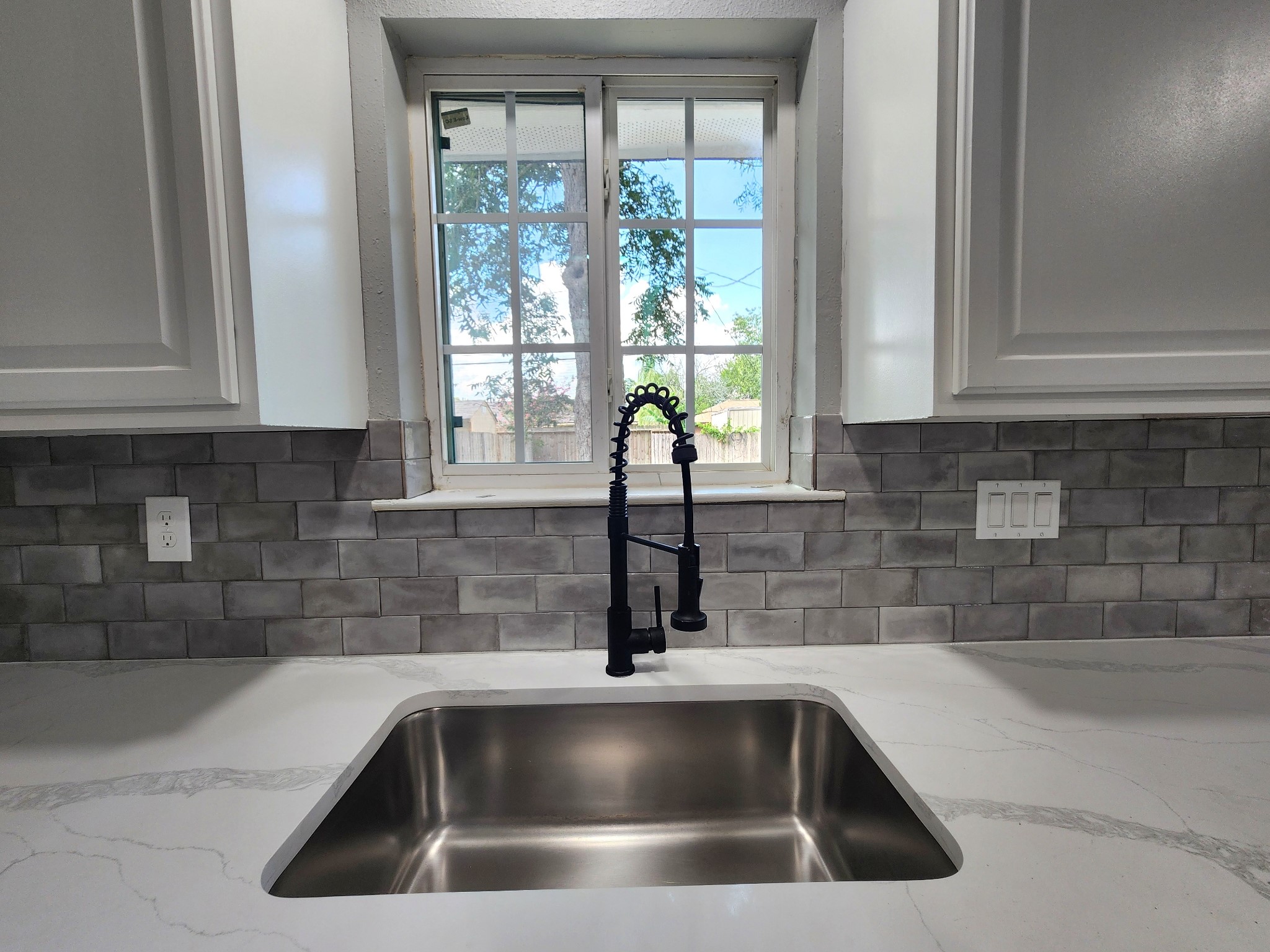 5914 Newquay Street Houston, TX 77085 - Photo 29 of 43 a kitchen with a sink and cabinets