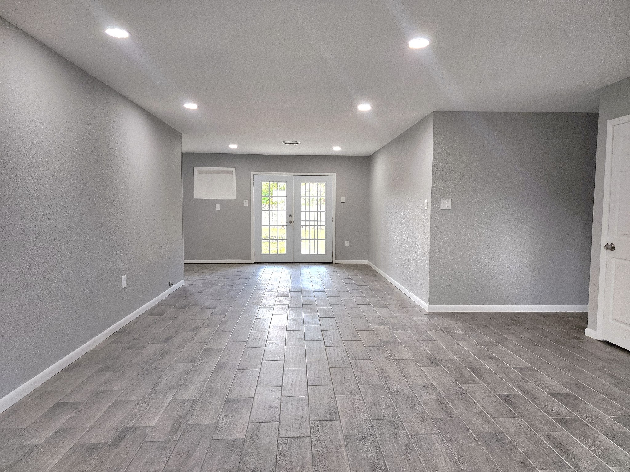 5914 Newquay Street Houston, TX 77085 - Photo 34 of 43 a view of an empty room with wooden floor and a window