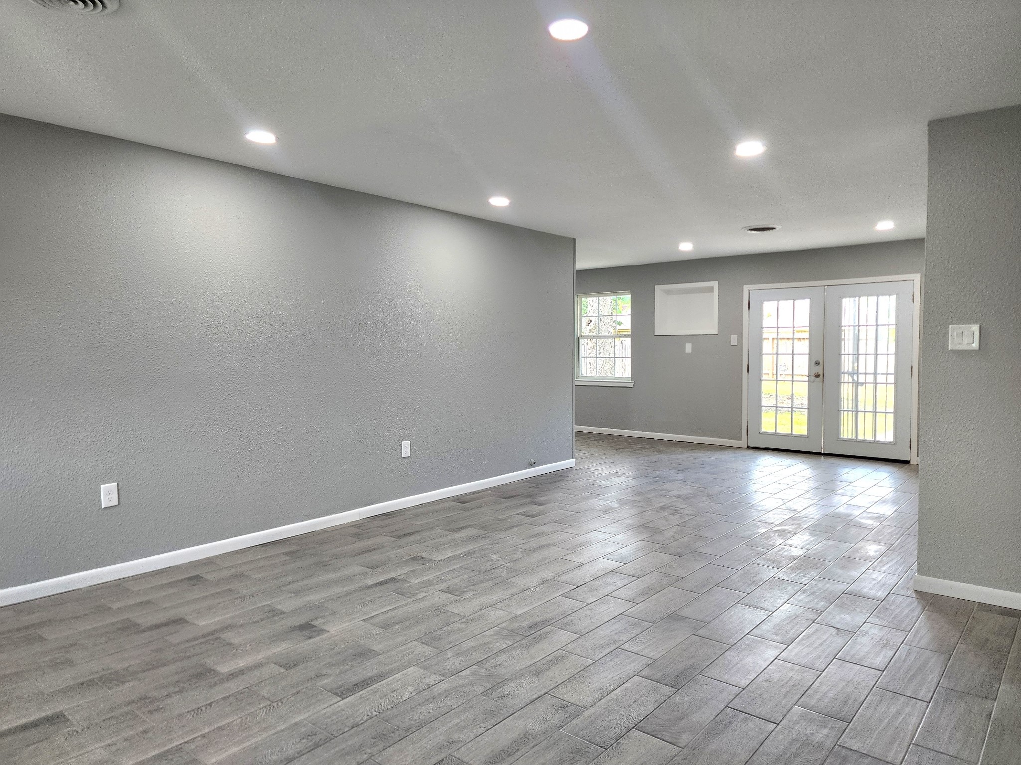 5914 Newquay Street Houston, TX 77085 - Photo 35 of 43 a view of an empty room with window and wooden floor