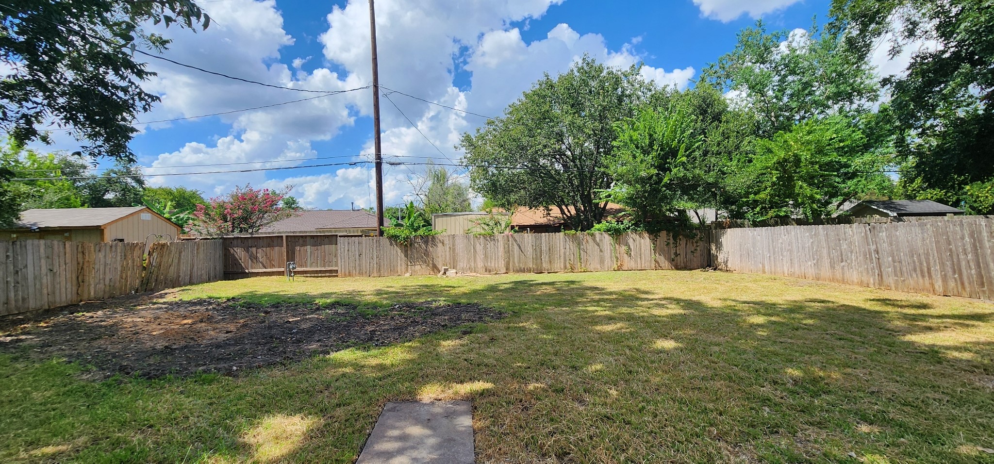 5914 Newquay Street Houston, TX 77085 - Photo 39 of 43 a backyard of a house with a garden and plants