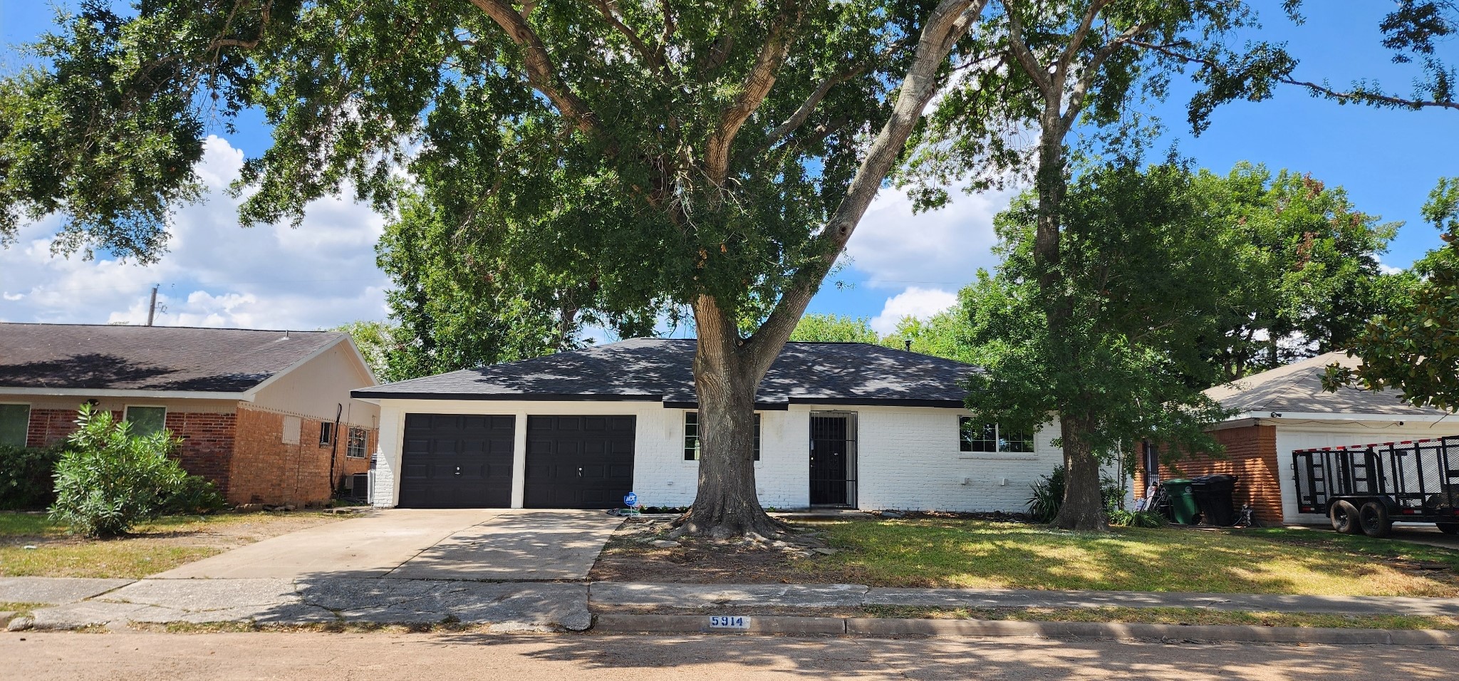 5914 Newquay Street Houston, TX 77085 - Photo 4 of 43 a front view of a house with yard and trees