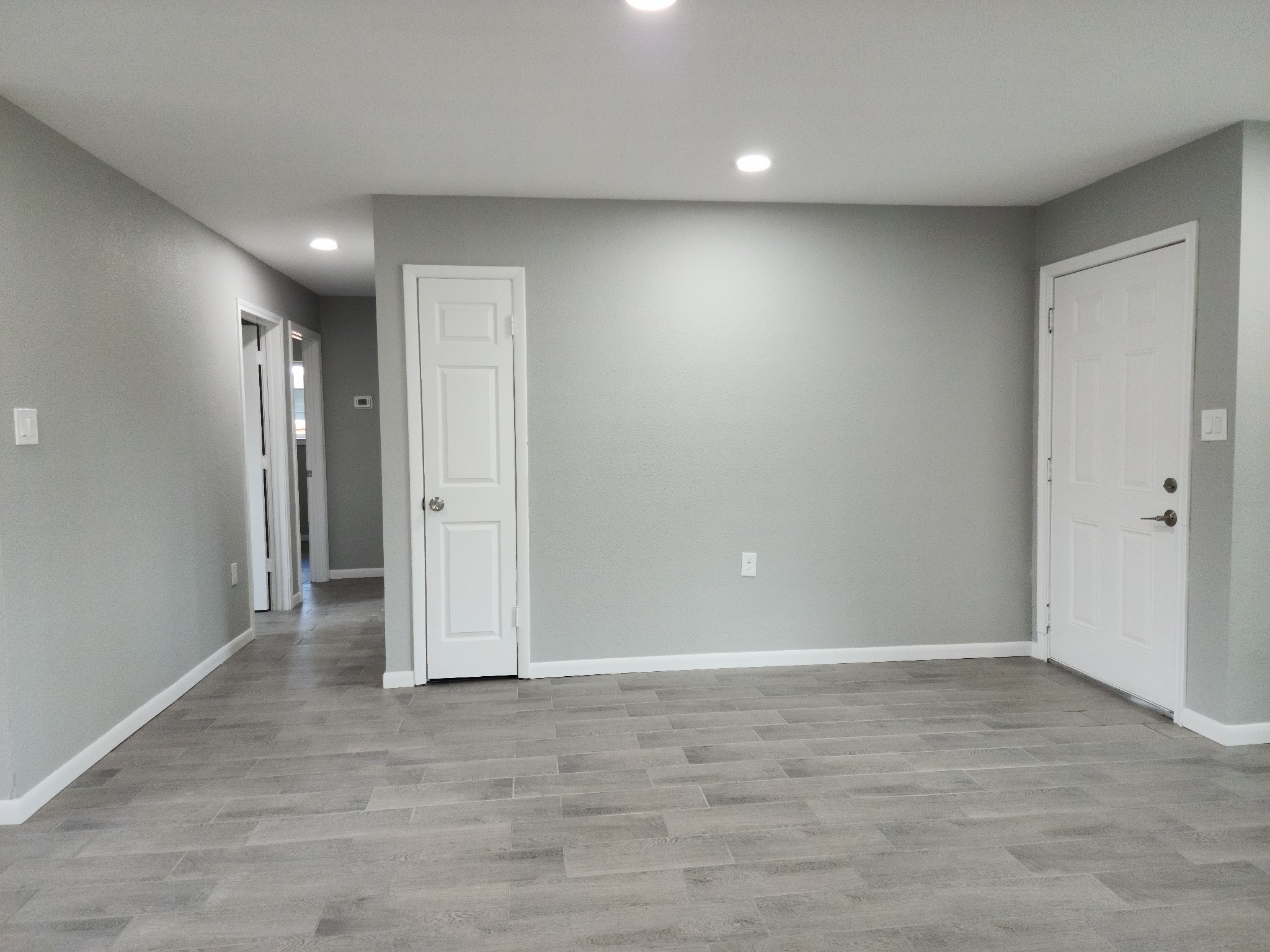 5914 Newquay Street Houston, TX 77085 - Photo 8 of 43 an empty room with wooden floor and windows