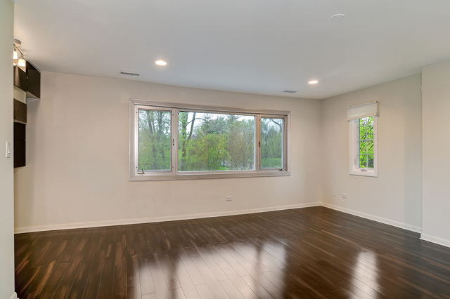 1000 Laurie Lane Burr Ridge, IL 60527 - Photo 18 of 36 a view of an empty room with wooden floor and a window
