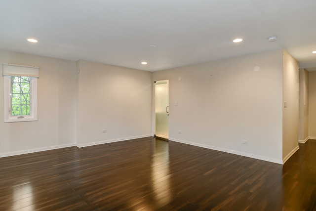 1000 Laurie Lane Burr Ridge, IL 60527 - Photo 19 of 36 a view of an empty room with wooden floor and a window
