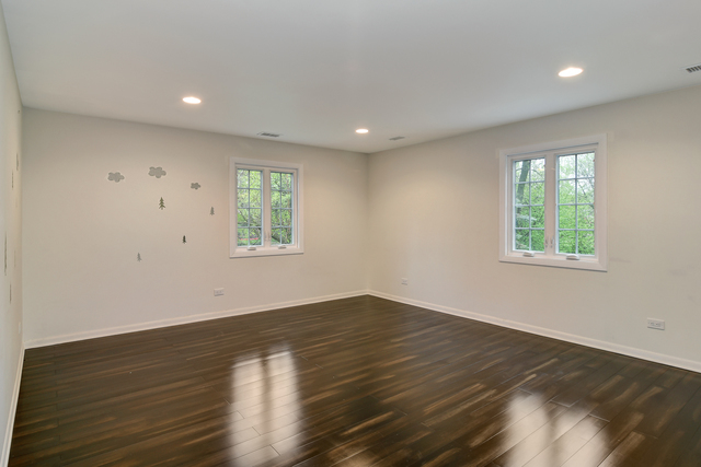 1000 Laurie Lane Burr Ridge, IL 60527 - Photo 23 of 36 an empty room with wooden floor and windows