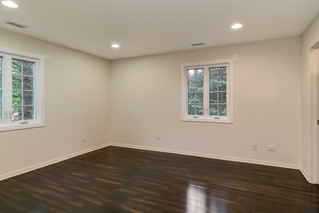 1000 Laurie Lane Burr Ridge, IL 60527 - Photo 27 of 36 a view of empty room with wooden floor and fan