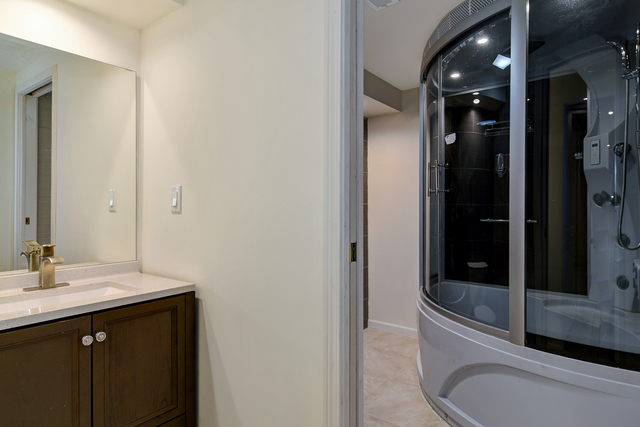 1000 Laurie Lane Burr Ridge, IL 60527 - Photo 33 of 36 a bathroom with a sink a toilet and shower