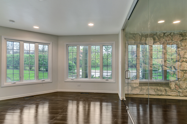 1000 Laurie Lane Burr Ridge, IL 60527 - Photo 7 of 36 a view of an empty room with wooden floor and a window