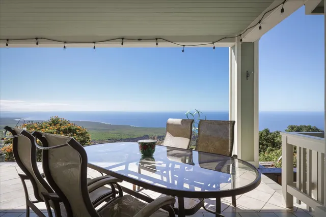 a view of a balcony dining table and chairs