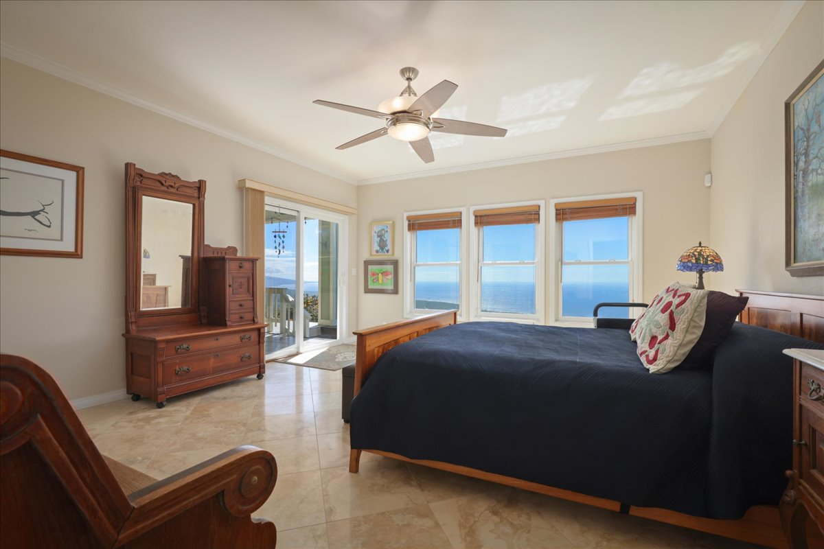 82-5957 Wakida Drive Captain Cook, HI 96704 - Photo 16 of 30 a bedroom with a bed and glass window