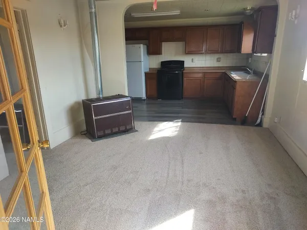 a kitchen with granite countertop a sink and a stove top oven