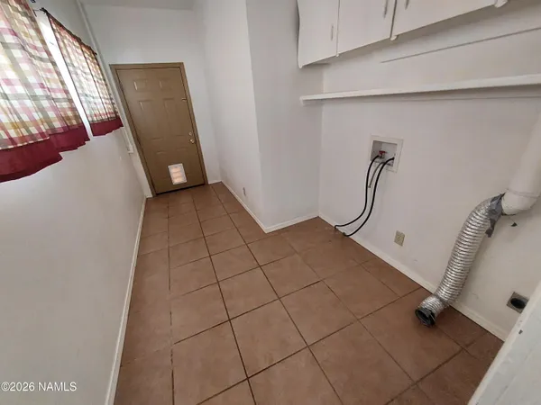 a view of a livingroom with an empty space and a window