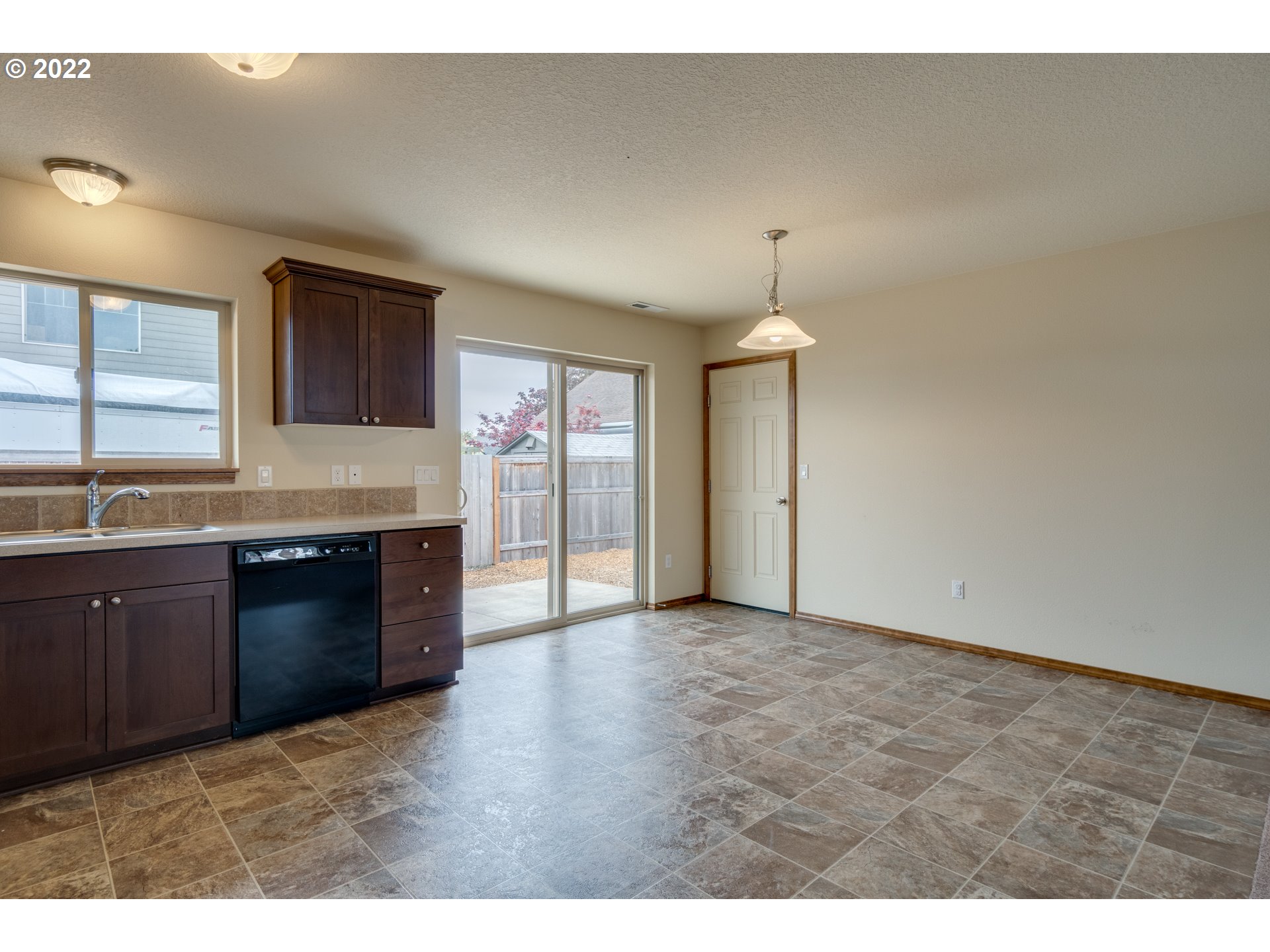 10923 Rees Street Northeast Donald, OR 97020 - Photo 9 of 27 a kitchen with granite countertop a stove and a refrigerator