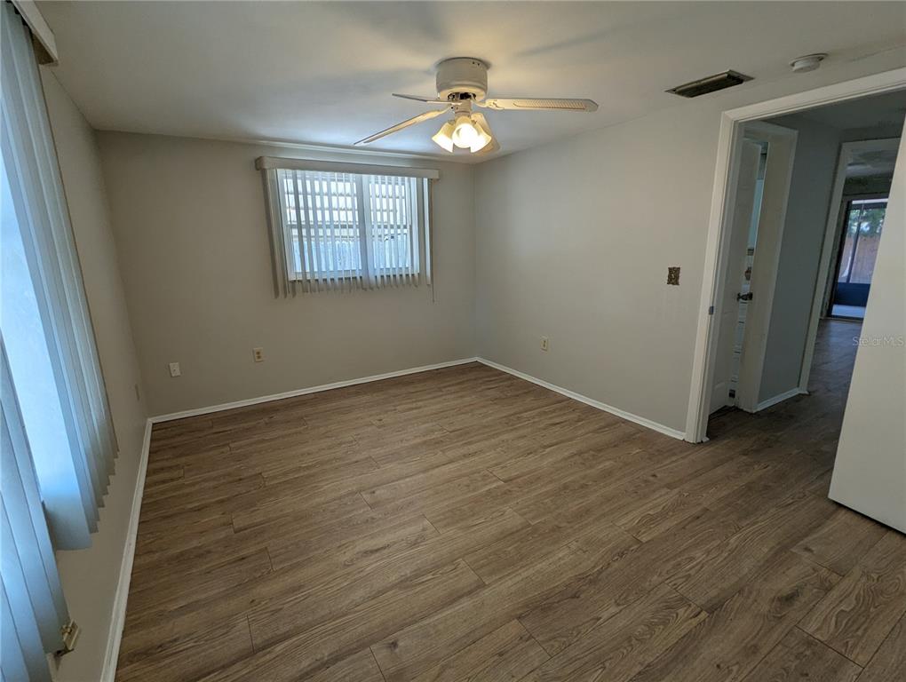 11230 Kapok Avenue Port Richey, FL 34668 - Photo 15 of 19 wooden floor in an empty room with a window