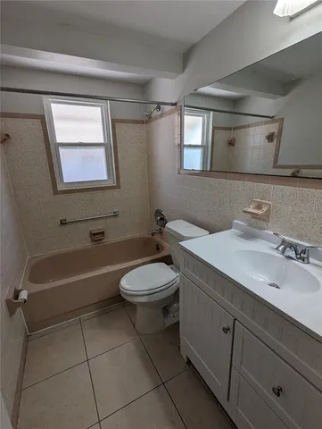 a bathroom with a sink a toilet and bathtub