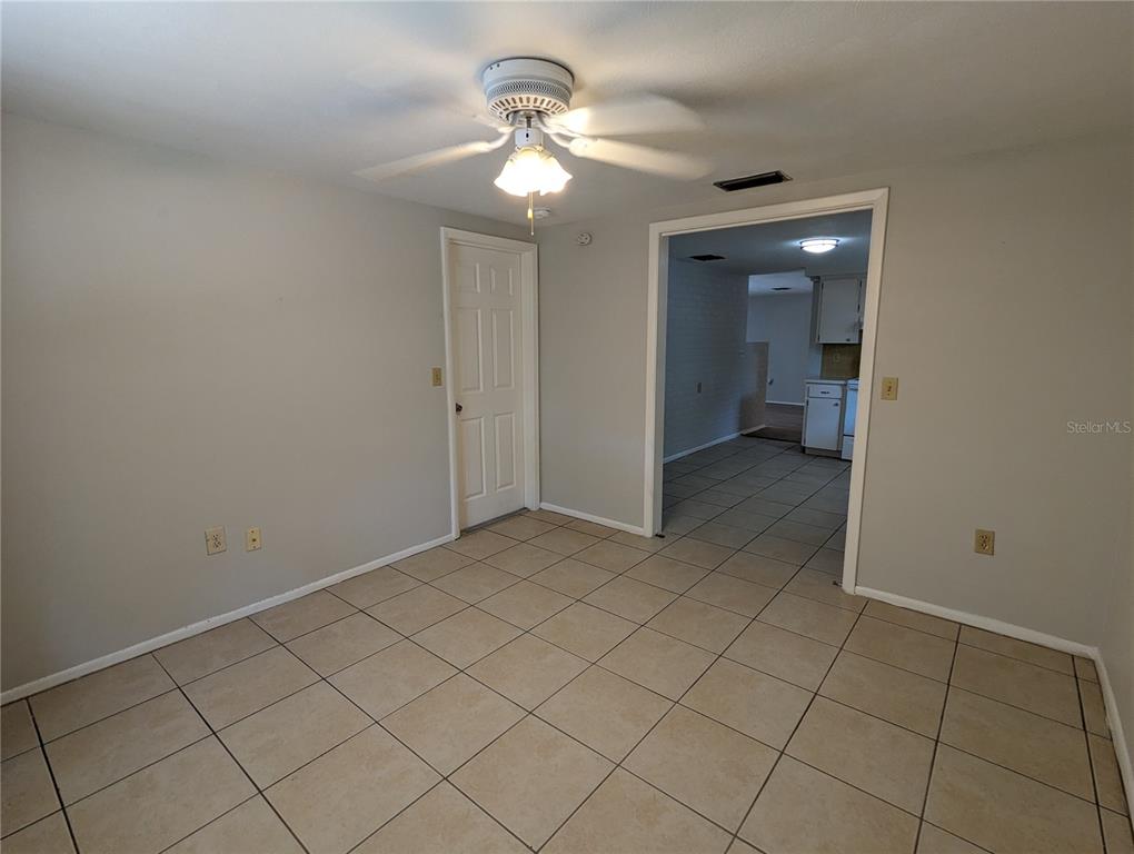 11230 Kapok Avenue Port Richey, FL 34668 - Photo 9 of 19 en empty room with a chandelier fan and closet