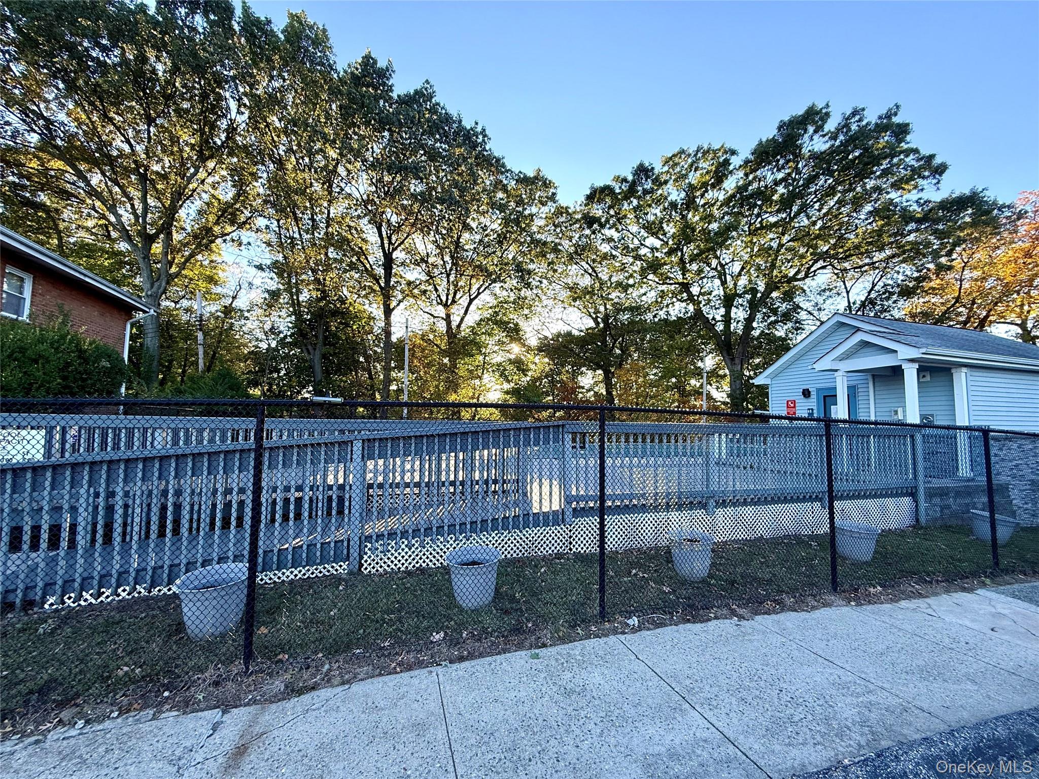 669 Pelham Road, Unit C10 New Rochelle, NY 10805 - Photo 13 of 13 a view of house with a small yard and wooden fence