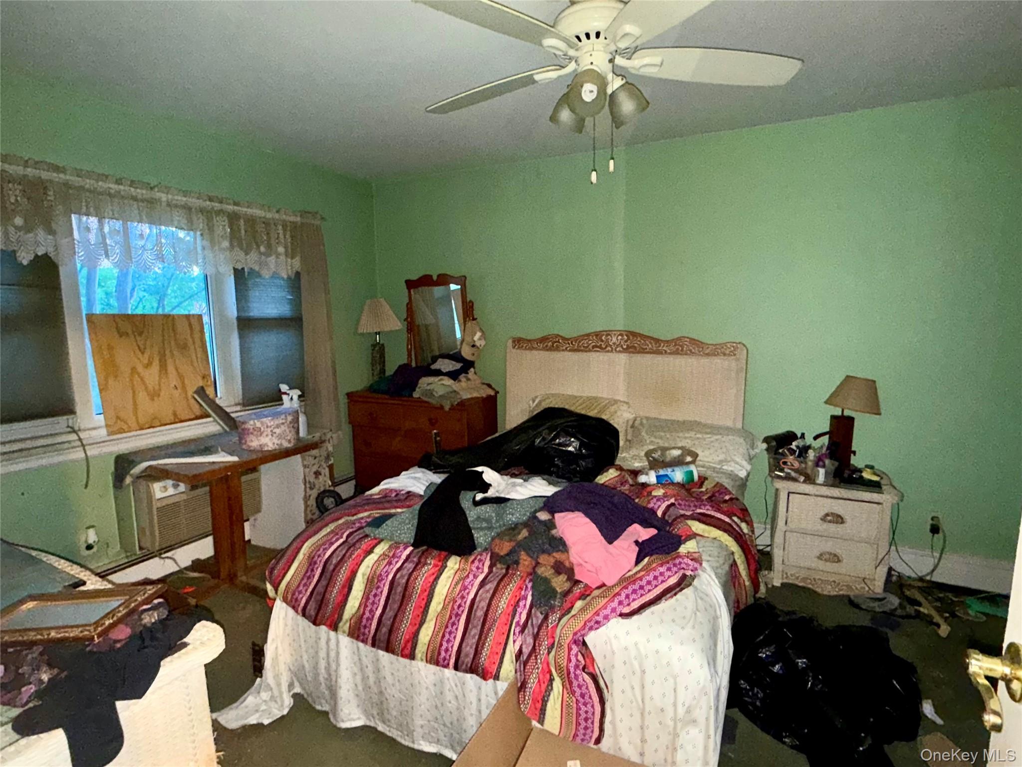 669 Pelham Road, Unit C10 New Rochelle, NY 10805 - Photo 7 of 13 a bedroom with a bed and a chandelier