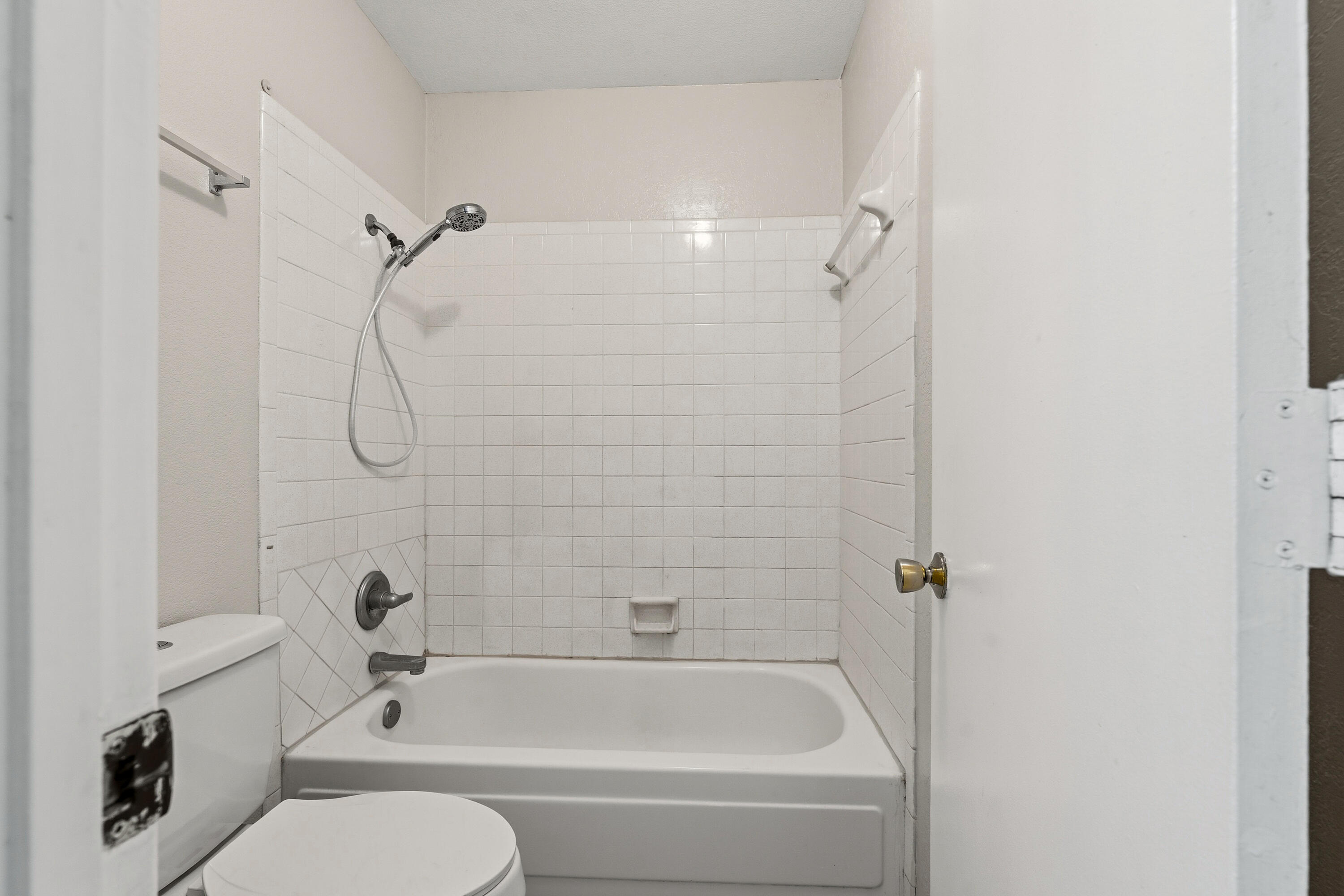 4725 48th Street Lubbock, TX 79414 - Photo 16 of 24 a bathroom with a granite countertop bathtub shower sink vanity and toilet