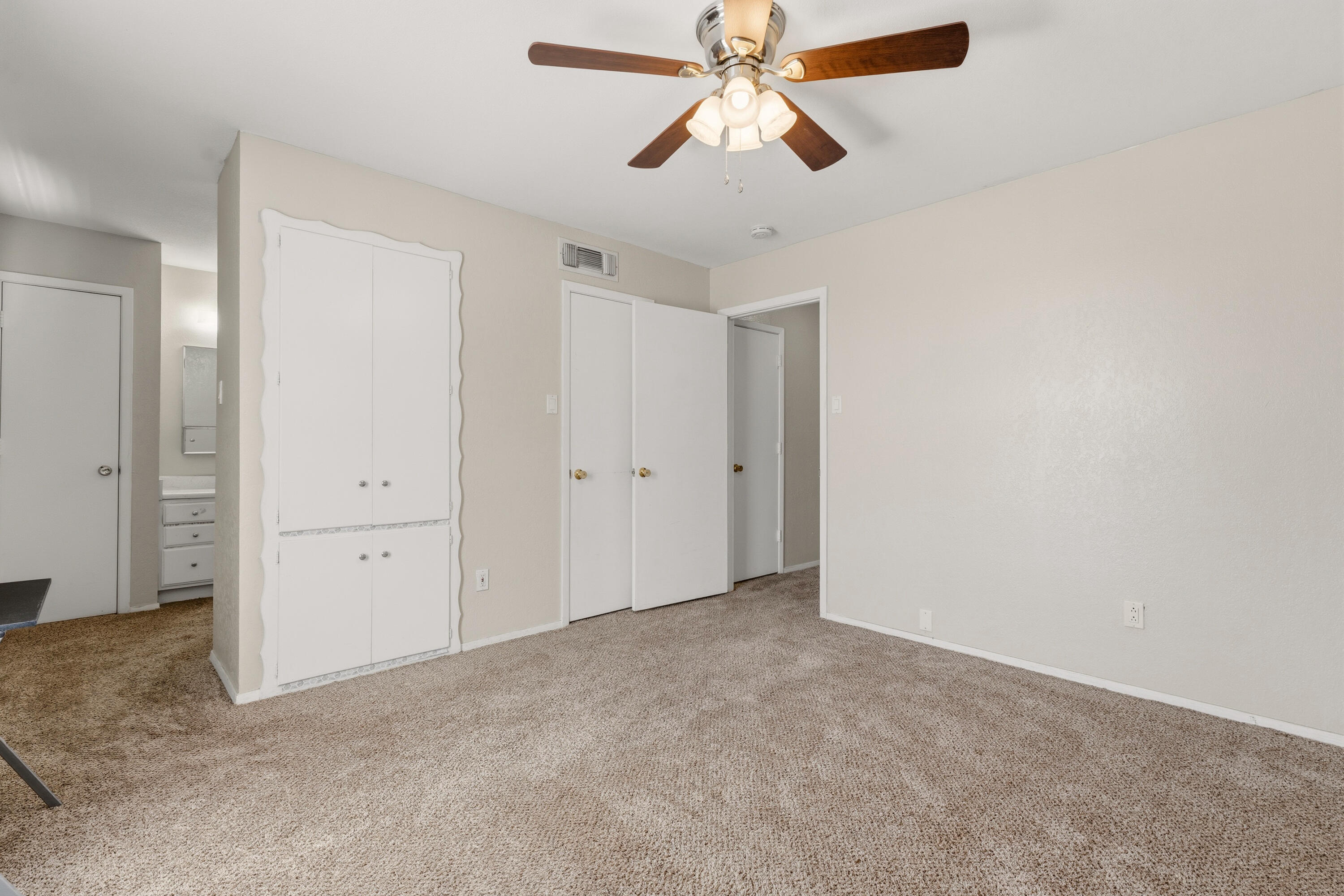 4725 48th Street Lubbock, TX 79414 - Photo 18 of 24 an empty room with closet and a chandelier fan