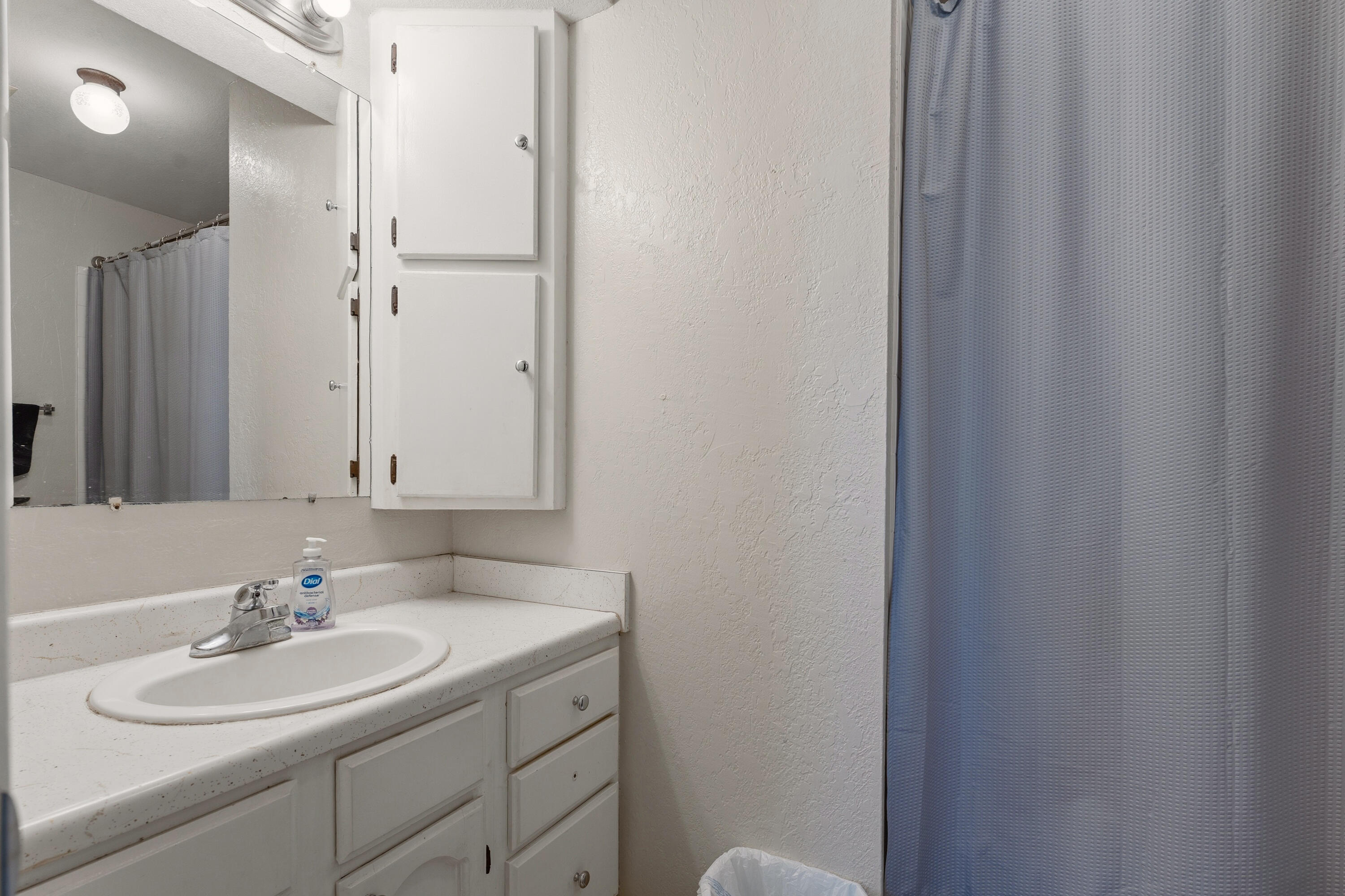 4725 48th Street Lubbock, TX 79414 - Photo 19 of 24 a bathroom with a sink and a mirror