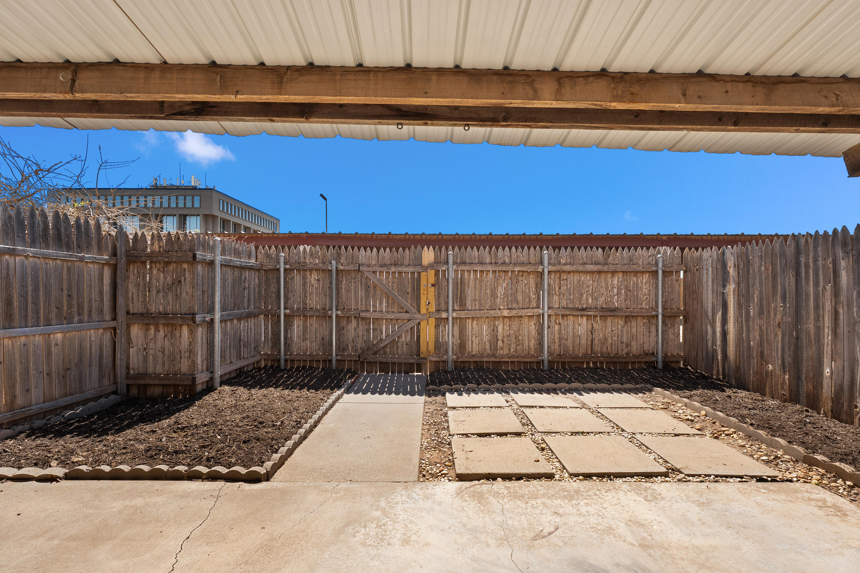 4725 48th Street Lubbock, TX 79414 - Photo 23 of 24 a view of a backyard with wooden fence