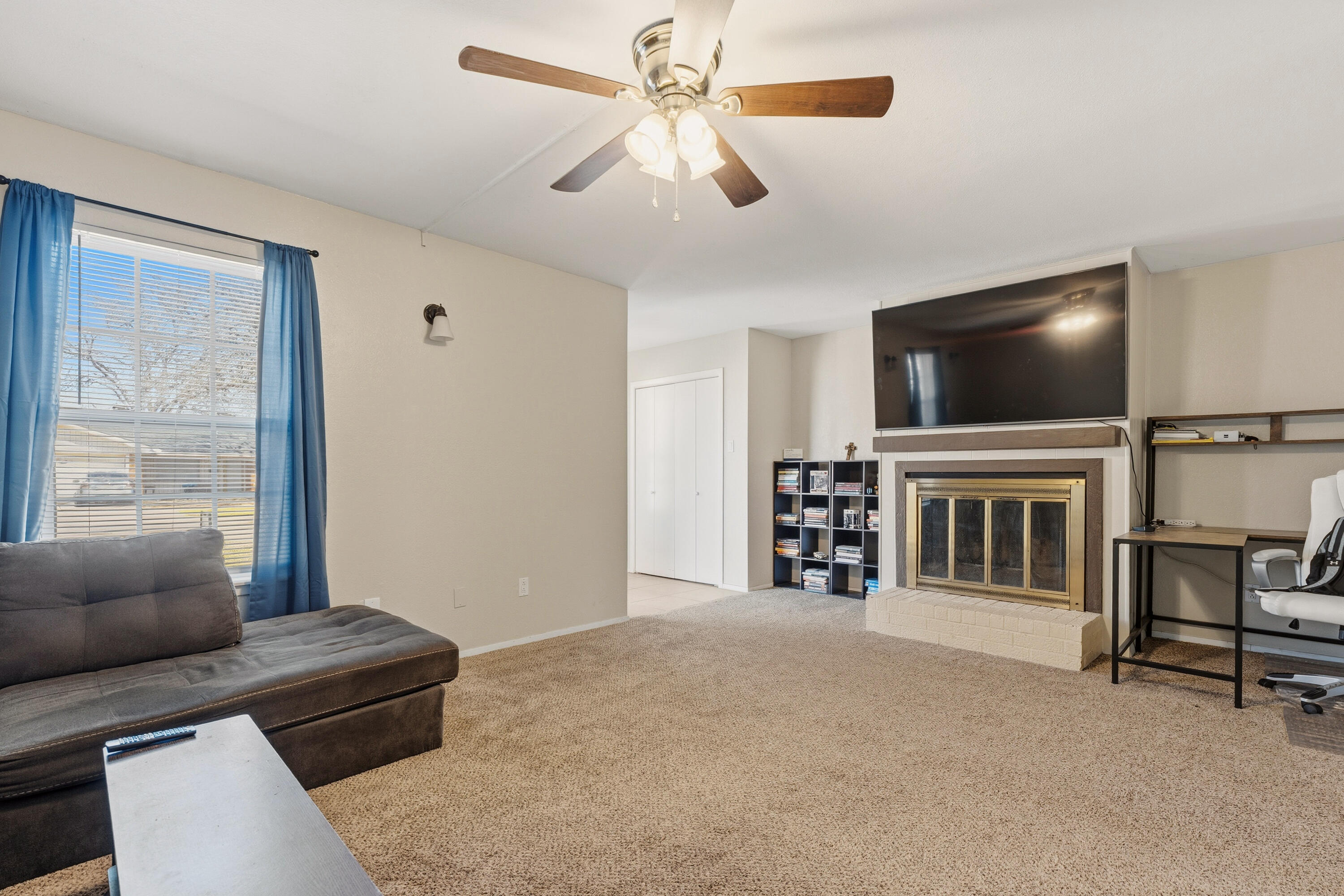 4725 48th Street Lubbock, TX 79414 - Photo 5 of 24 a living room with furniture and a flat screen tv