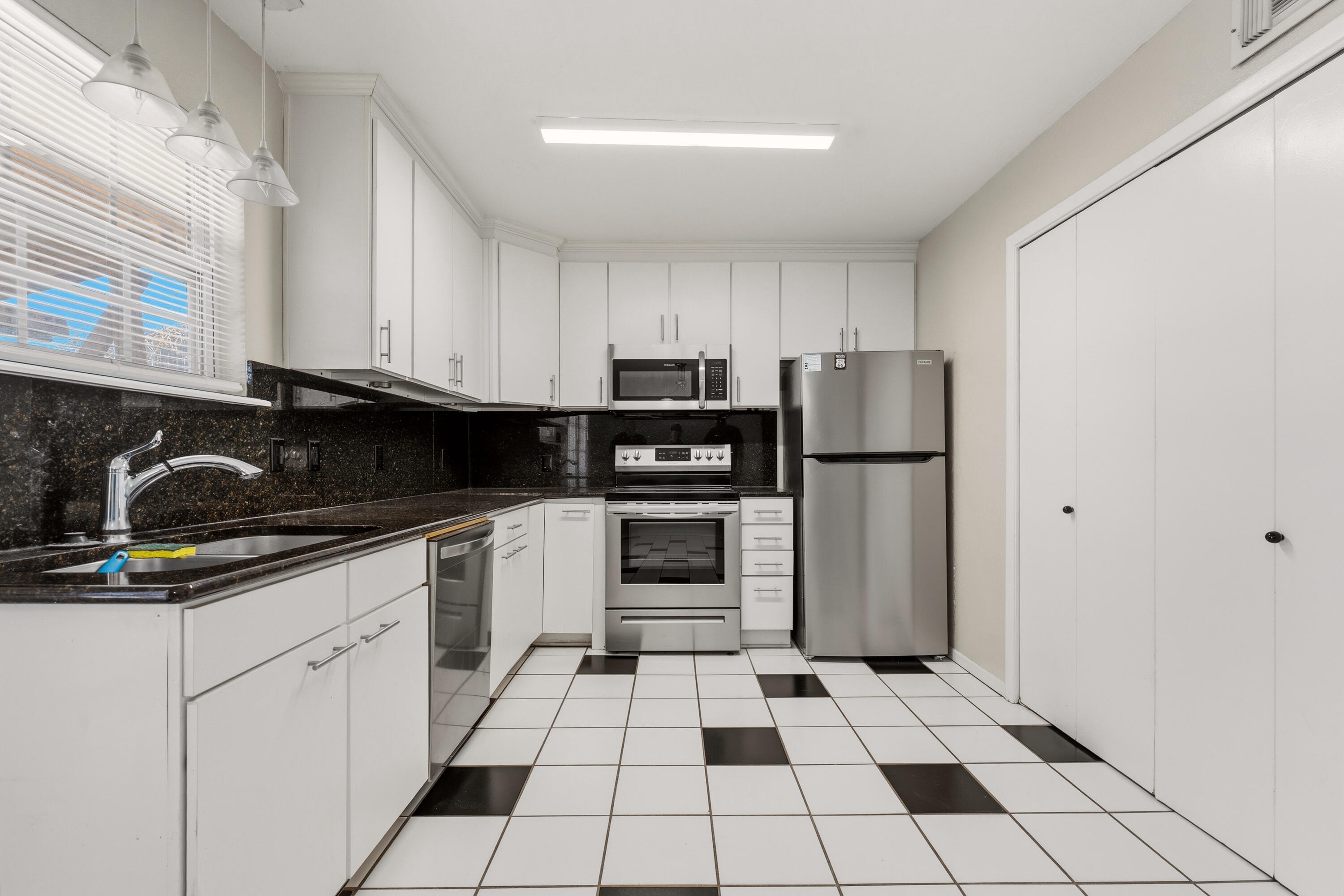 4725 48th Street Lubbock, TX 79414 - Photo 8 of 24 a kitchen with a refrigerator sink and cabinets