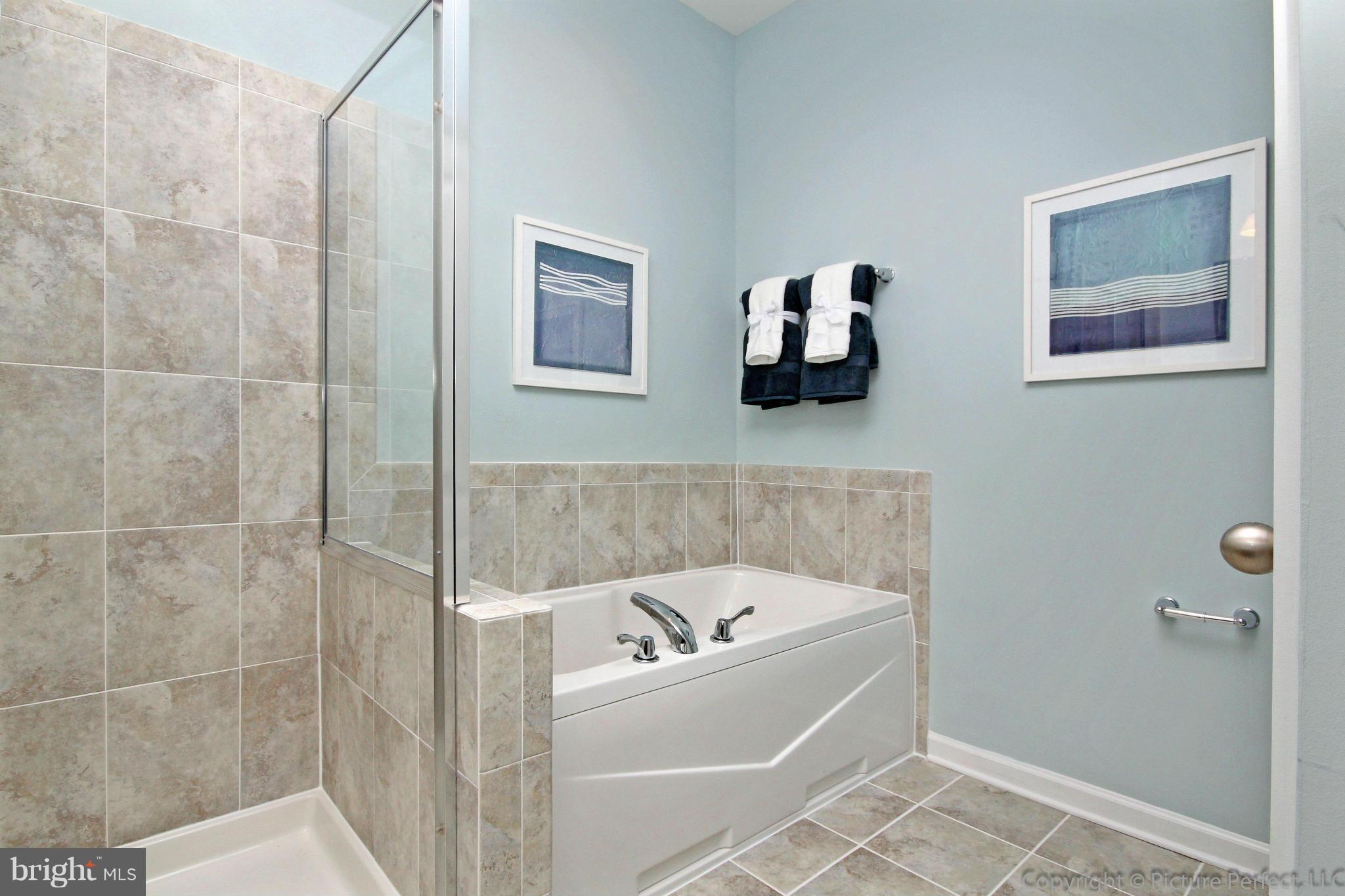 112 Mill Pond Road Frederick, MD 21701 - Photo 16 of 23 a bathroom with a bathtub and a shower
