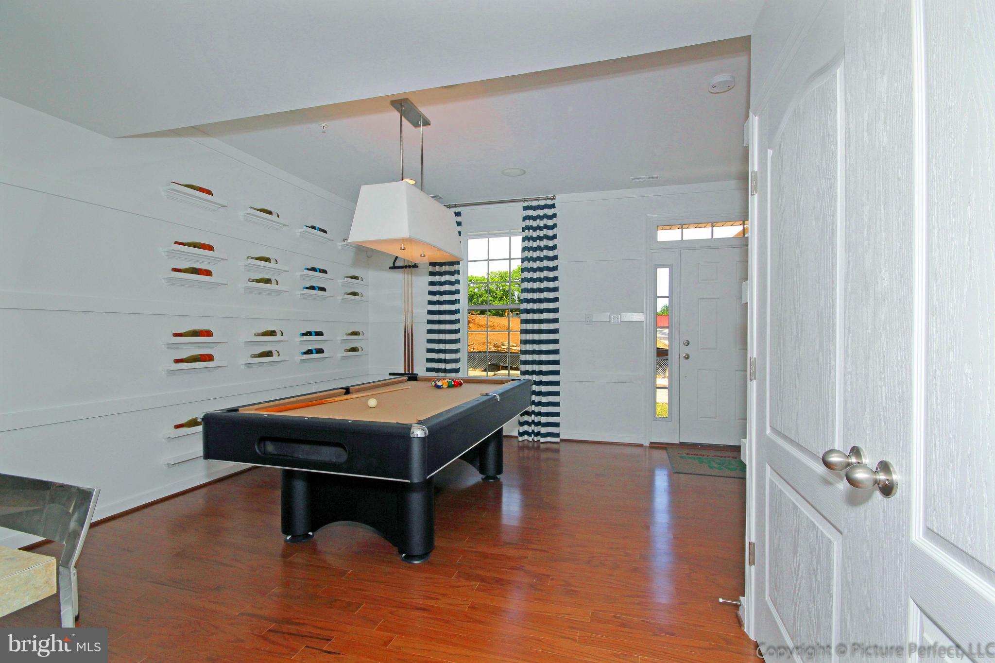 112 Mill Pond Road Frederick, MD 21701 - Photo 21 of 23 a room with furniture a lamp and a chandelier