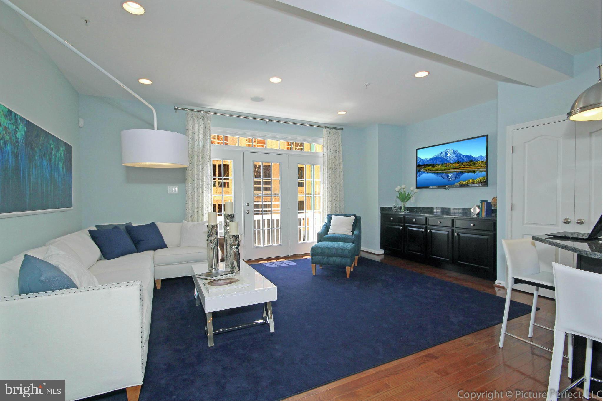 112 Mill Pond Road Frederick, MD 21701 - Photo 10 of 23 a living room with furniture a rug kitchen view and a large window
