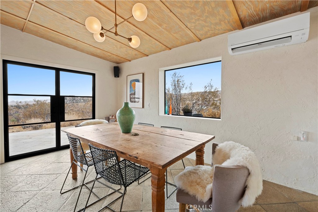 51222 Gamma Gulch Road Landers, CA 92285 - Photo 14 of 73 a view of a dining room with furniture window and wooden floor