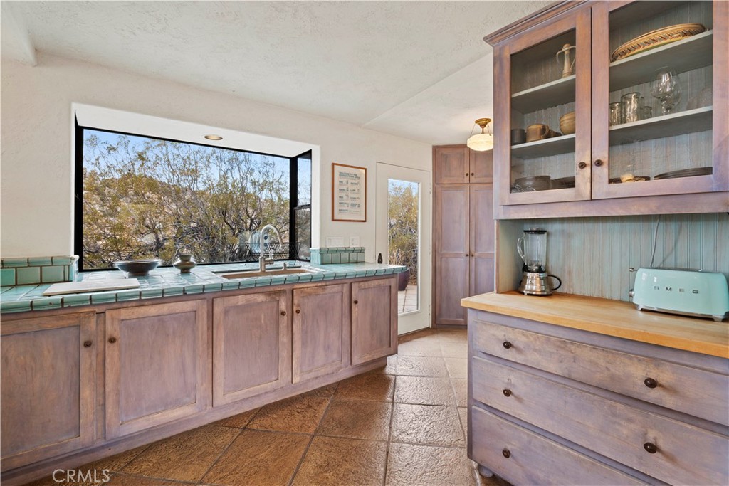 51222 Gamma Gulch Road Landers, CA 92285 - Photo 15 of 73 a kitchen with cabinets wooden floor and a large window