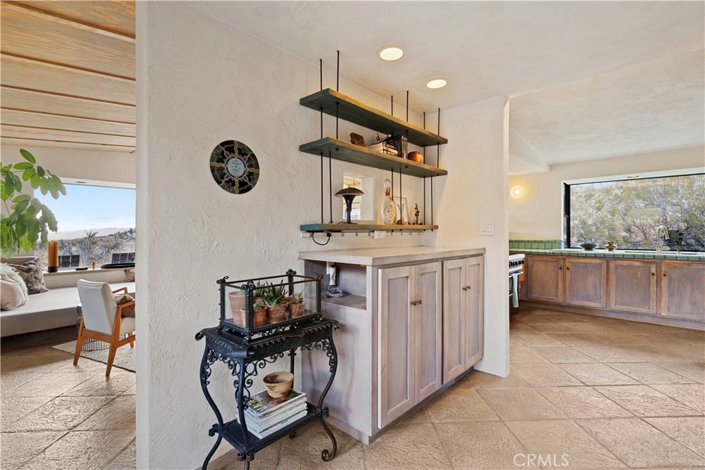 51222 Gamma Gulch Road Landers, CA 92285 - Photo 24 of 73 a kitchen with a sink a stove and a view of living room