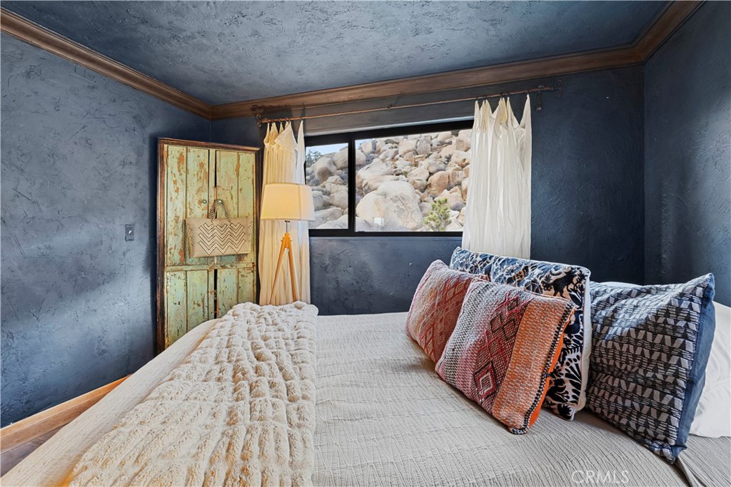 51222 Gamma Gulch Road Landers, CA 92285 - Photo 28 of 73 a bedroom with a large bed and a large window