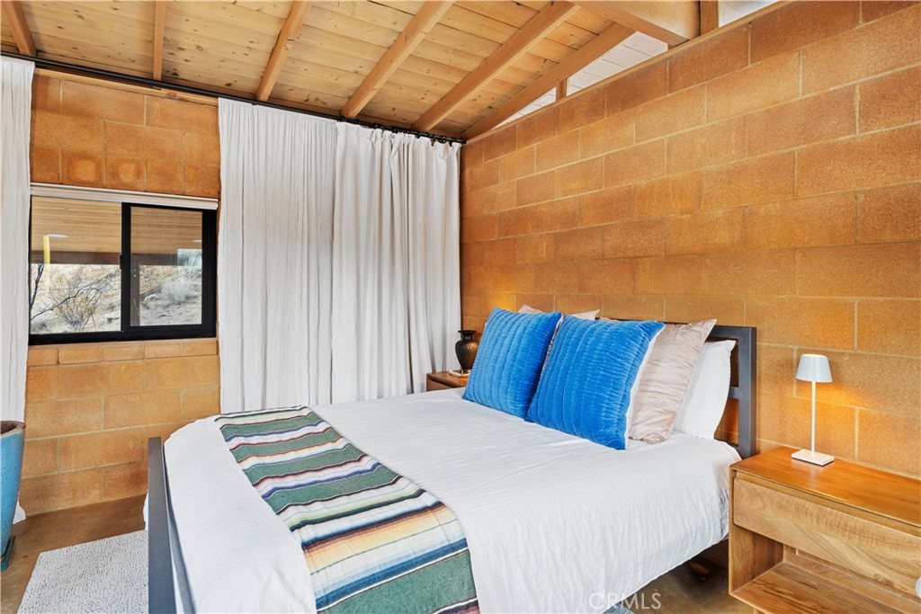 51222 Gamma Gulch Road Landers, CA 92285 - Photo 38 of 73 a bedroom with a bed and wooden floor