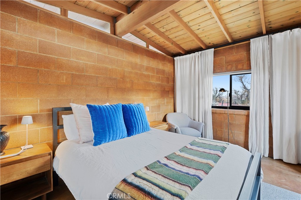 51222 Gamma Gulch Road Landers, CA 92285 - Photo 39 of 73 a bed sitting in a bedroom next to a window