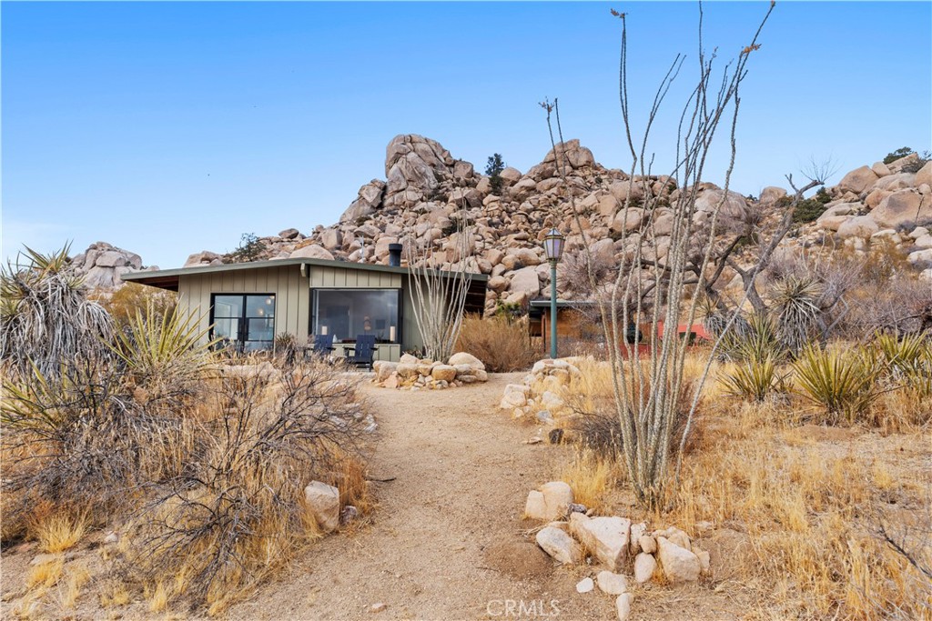 51222 Gamma Gulch Road Landers, CA 92285 - Photo 47 of 73 a view of a house with a wooden bench in a backyard