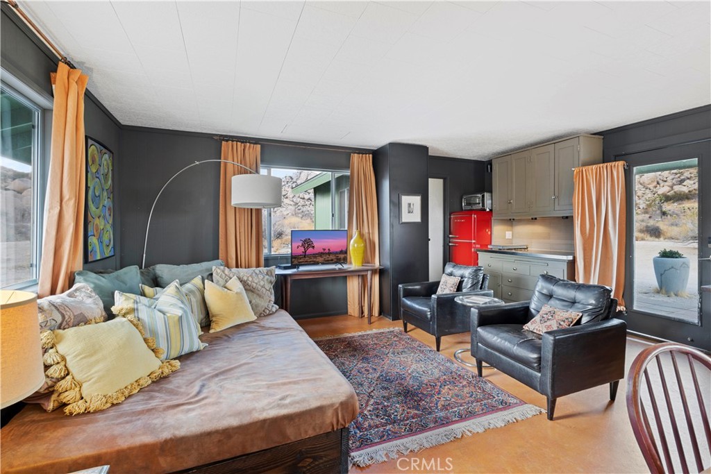 51222 Gamma Gulch Road Landers, CA 92285 - Photo 56 of 73 a living room with furniture fireplace and a large window