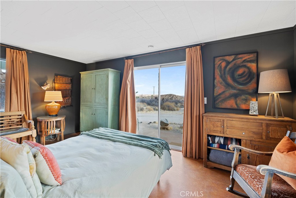 51222 Gamma Gulch Road Landers, CA 92285 - Photo 57 of 73 a bedroom with a bed and dresser next to a window