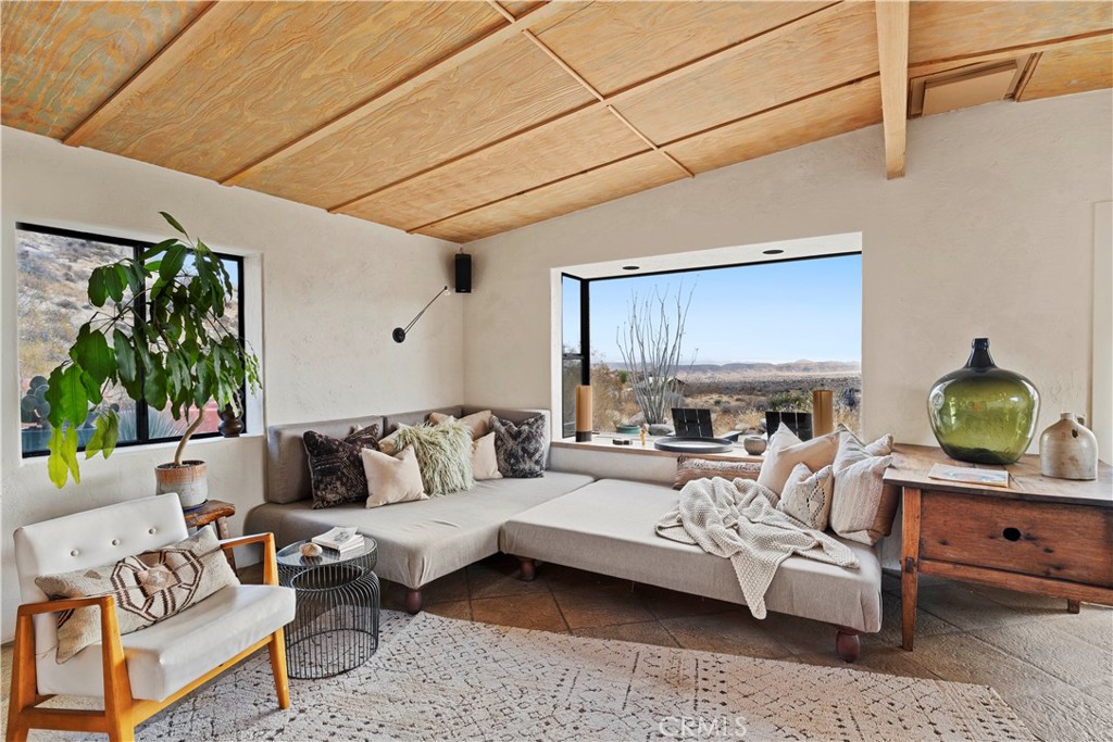 51222 Gamma Gulch Road Landers, CA 92285 - Photo 6 of 73 a living room with furniture a lamp and a potted plant