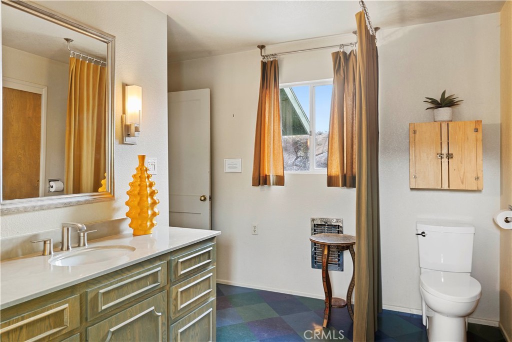 51222 Gamma Gulch Road Landers, CA 92285 - Photo 63 of 73 a bathroom with a granite countertop sink toilet and mirror