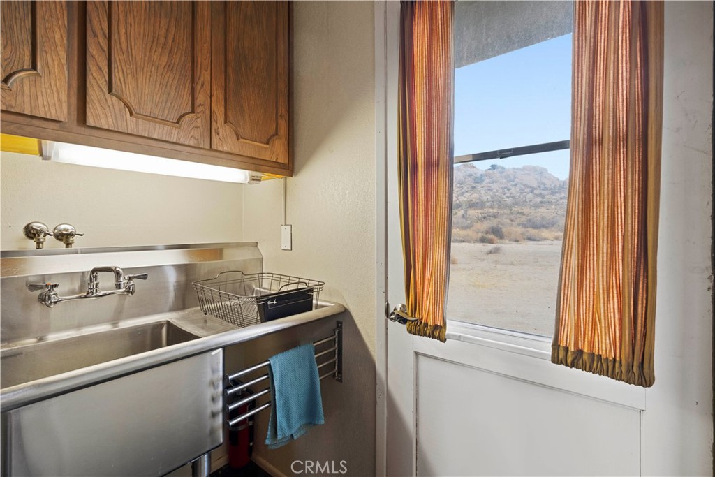 51222 Gamma Gulch Road Landers, CA 92285 - Photo 64 of 73 a kitchen with a sink cabinets and a window