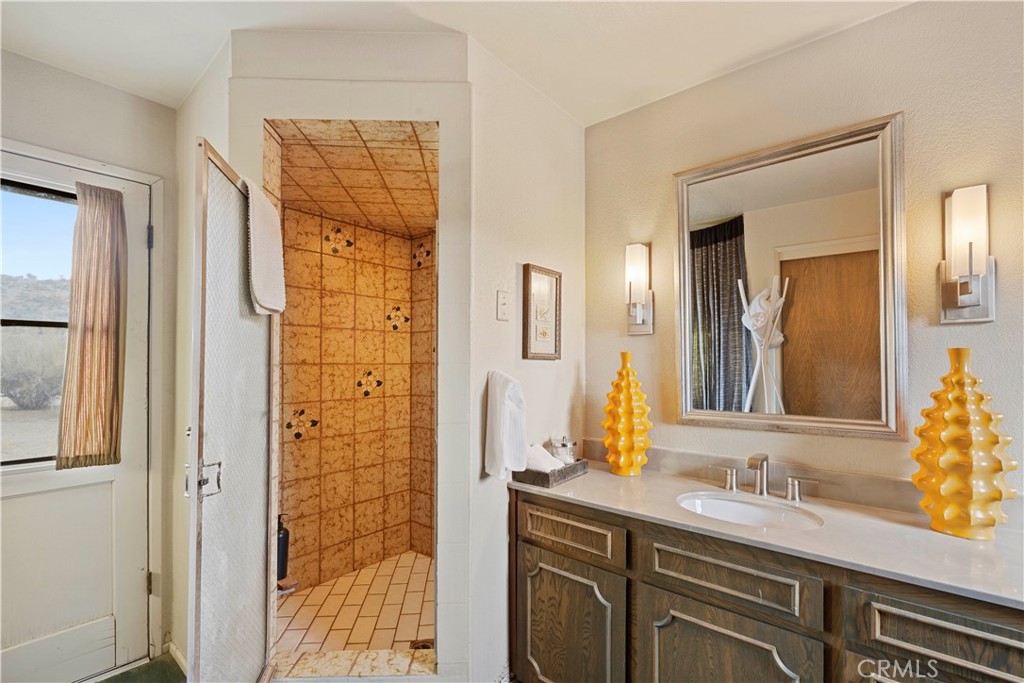 51222 Gamma Gulch Road Landers, CA 92285 - Photo 66 of 73 a bathroom with a granite countertop sink and a mirror