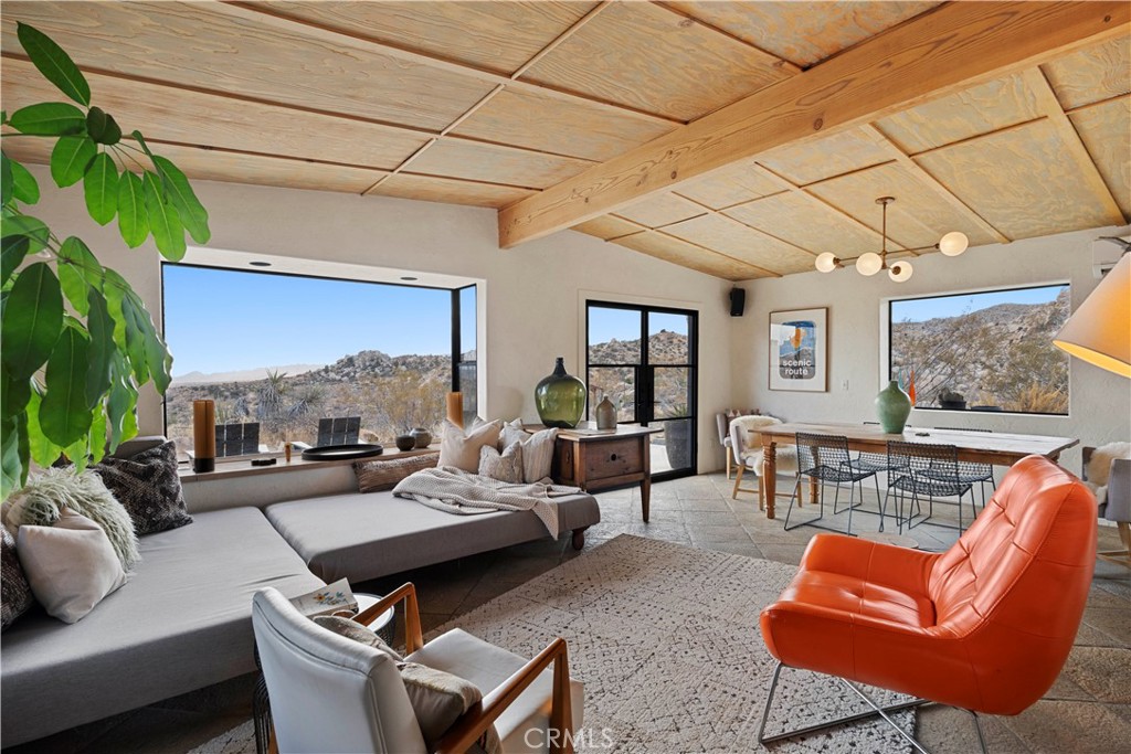 51222 Gamma Gulch Road Landers, CA 92285 - Photo 7 of 73 a living room with furniture a fireplace and a potted plant
