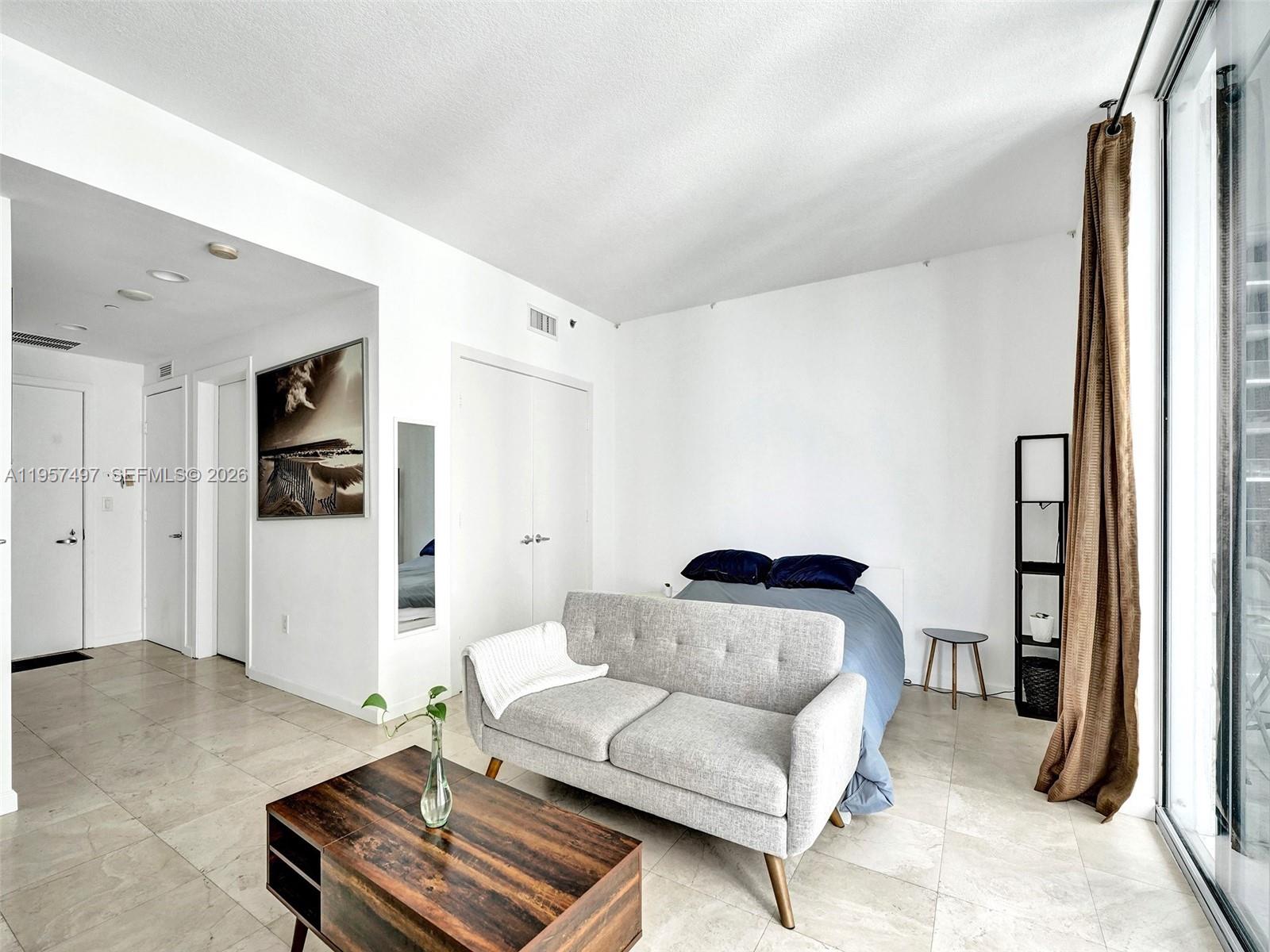 1050 Brickell Avenue, Unit 2722 Miami, FL 33131 - Photo 11 of 19 a living room with furniture and a rug